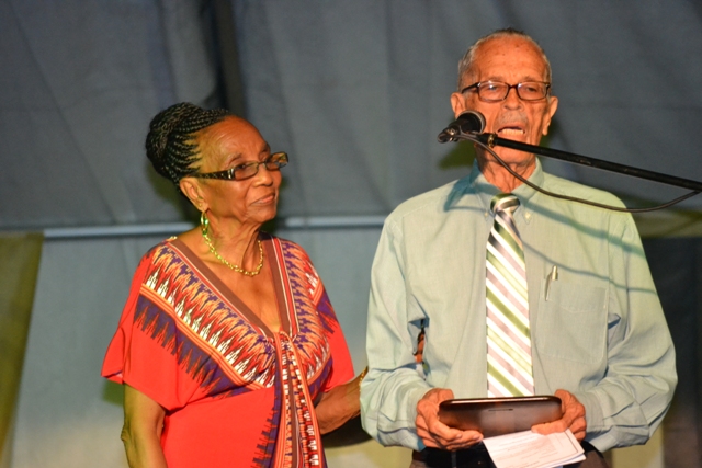 One of two surviving members of the Culturama Board of Trustees (The Board) Arthur Evelyn, receiving a plaque from Irma Johnson on behalf of the Culturama Committee 2015. She was an Ex Officio member, who served the Board as Secretary. Evelyn, is being honoured for his sterling contribution to the development and preservation of culture on Nevis during the opening ceremony of Culturama 2015 at the Charlestown Waterfront on July 23, 2015